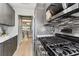 A kitchen with stainless steel gas range, microwave, and gray cabinets at 2960 59Th S St # 303, Gulfport, FL 33707