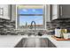 A close-up of a modern kitchen sink with beautiful view from the window at 2960 59Th S St # 303, Gulfport, FL 33707