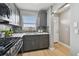Renovated kitchen with gray cabinets, modern countertops, and stainless steel appliances at 2960 59Th S St # 303, Gulfport, FL 33707