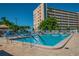 Large swimming pool surrounded by lounge chairs and tropical landscaping on a sunny day at 2960 59Th S St # 303, Gulfport, FL 33707