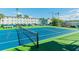 Outdoor tennis court with blue and green surface near building with available parking at 2960 59Th S St # 303, Gulfport, FL 33707