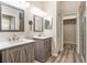 Bathroom featuring double vanities, modern fixtures, and a walk-in closet at 30753 Pumpkin Ridge Dr, Wesley Chapel, FL 33543