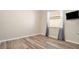 Comfortable bedroom featuring wood-look floors, neutral paint, and a window at 30753 Pumpkin Ridge Dr, Wesley Chapel, FL 33543