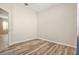 Spacious bedroom featuring wood-look floors and open doorway at 30753 Pumpkin Ridge Dr, Wesley Chapel, FL 33543