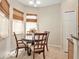 Bright breakfast nook featuring a round table, four chairs, and natural light from large windows at 30753 Pumpkin Ridge Dr, Wesley Chapel, FL 33543