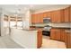 Well-lit kitchen featuring stainless steel oven, granite countertops, and ample cabinet space at 30753 Pumpkin Ridge Dr, Wesley Chapel, FL 33543