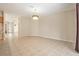 Expansive living space displays tile flooring, a decorative light fixture, and open access to other rooms at 30753 Pumpkin Ridge Dr, Wesley Chapel, FL 33543