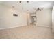 Open living room with neutral walls, tile flooring, ceiling fans, and plenty of natural light at 30753 Pumpkin Ridge Dr, Wesley Chapel, FL 33543