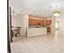 Open-concept living space features a kitchen with wood cabinets, dining area, and tile flooring throughout at 30753 Pumpkin Ridge Dr, Wesley Chapel, FL 33543