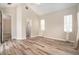 Spacious bedroom with vaulted ceiling, wood floors, and natural light, plus an arched doorway at 30753 Pumpkin Ridge Dr, Wesley Chapel, FL 33543