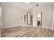 Open bedroom featuring wood floors, neutral walls, ceiling fan and adjacent bathroom and enclosed patio at 30753 Pumpkin Ridge Dr, Wesley Chapel, FL 33543