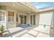 Covered patio with blue rug and stylish lighting fixtures for outdoor living at 30753 Pumpkin Ridge Dr, Wesley Chapel, FL 33543