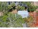 Aerial view of the property showcasing lush landscaping, mature trees, and the unique roofline of the house at 317 19Th S Ave, St Petersburg, FL 33705