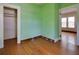 Bedroom with hardwood floors, closet, and view into an adjacent room at 317 19Th S Ave, St Petersburg, FL 33705