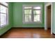 Cozy bedroom featuring hardwood floors and natural light from large windows at 317 19Th S Ave, St Petersburg, FL 33705