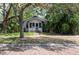 Charming bungalow-style home with a brick sidewalk and lush, mature landscaping at 317 19Th S Ave, St Petersburg, FL 33705
