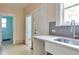 Kitchen sink area featuring tile backsplash, modern faucet, and windows allowing for natural light to come in at 317 19Th S Ave, St Petersburg, FL 33705
