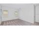 Bright, carpeted bedroom features two windows that bring in natural light at 33306 Castaway Loop, Wesley Chapel, FL 33543