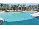Relaxing community pool with lounge chairs and covered seating area for residents at 33306 Castaway Loop, Wesley Chapel, FL 33543