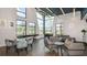 This contemporary game room features high ceilings, comfortable seating, and various games at 33306 Castaway Loop, Wesley Chapel, FL 33543