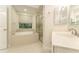 Well-lit bathroom featuring soaking tub, glass shower, and modern fixtures at 3415 Heards Ferry Dr, Tampa, FL 33618
