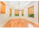 Cozy dining area with natural light, hardwood floors and woven shades at 3415 Heards Ferry Dr, Tampa, FL 33618