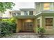 Back exterior view of a home with a brick patio and lush landscaping at 3415 Heards Ferry Dr, Tampa, FL 33618