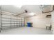 Spacious two-car garage featuring painted floor, garage door opener, and utility sink at 3415 Heards Ferry Dr, Tampa, FL 33618