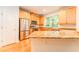 Well-lit kitchen featuring stainless steel appliances, wooden cabinetry and granite countertops at 3415 Heards Ferry Dr, Tampa, FL 33618