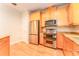Well-equipped kitchen with stainless steel appliances, granite countertops and hardwood floors at 3415 Heards Ferry Dr, Tampa, FL 33618