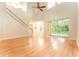 Open-concept living room with hardwood floors, large windows and glass sliding doors to the backyard at 3415 Heards Ferry Dr, Tampa, FL 33618