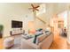 Bright living room with a ceiling fan, hardwood floors, and neutral-colored furniture at 3415 Heards Ferry Dr, Tampa, FL 33618