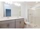 Double vanity bathroom with a glass shower, a large mirror, and neutral-colored cabinets at 34234 Polacca Ln, Wesley Chapel, FL 33543