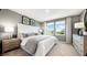 Serene main bedroom features neutral decor, plush carpeting, and large windows offering ample natural light at 34234 Polacca Ln, Wesley Chapel, FL 33543