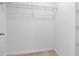 Walk-in closet with white walls, neutral carpet, and a wire shelf for organized storage at 34234 Polacca Ln, Wesley Chapel, FL 33543