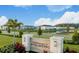 Scenic view of The Townhomes at River Landing entrance with lush landscaping and view of the townhome community at 34234 Polacca Ln, Wesley Chapel, FL 33543