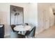 Cozy dining area with a modern round table, stylish chairs, and a view into the adjacent living space at 34234 Polacca Ln, Wesley Chapel, FL 33543