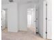 Bright hallway with neutral carpet leads to bedrooms and closet, offering ample storage and access at 34234 Polacca Ln, Wesley Chapel, FL 33543