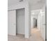 Bright hallway with neutral carpet leads to bedrooms and closet with sliding door, offering ample storage at 34234 Polacca Ln, Wesley Chapel, FL 33543