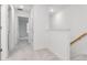 Upstairs hallway with carpet and an open door at 34234 Polacca Ln, Wesley Chapel, FL 33543
