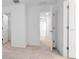 Bright hallway features neutral carpet, with white doors leading to other rooms in the house at 34234 Polacca Ln, Wesley Chapel, FL 33543