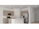 Bright kitchen features stainless appliances, center island, neutral cabinets, and a pantry at 34234 Polacca Ln, Wesley Chapel, FL 33543