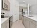 Well-equipped kitchen features stainless steel appliances, neutral cabinets, and a center island at 34234 Polacca Ln, Wesley Chapel, FL 33543