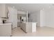 Open kitchen featuring an island, stainless steel appliances, and white countertops at 34234 Polacca Ln, Wesley Chapel, FL 33543