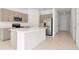 Modern kitchen with stainless steel appliances and a large island at 34234 Polacca Ln, Wesley Chapel, FL 33543