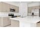 Bright kitchen features stainless appliances, neutral cabinets, a center island with a sink at 34234 Polacca Ln, Wesley Chapel, FL 33543