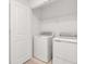 Well-lit laundry room with a washer and dryer, offering convenience and functionality at 34234 Polacca Ln, Wesley Chapel, FL 33543