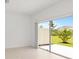 Bright living room featuring tile flooring and sliding glass doors leading to the outdoor area at 34234 Polacca Ln, Wesley Chapel, FL 33543