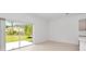 Bright living room with sliding glass doors offering scenic views at 34234 Polacca Ln, Wesley Chapel, FL 33543