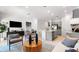 Modern living room showcases an open-concept layout with neutral tones, stylish furniture and stainless steel appliances at 34234 Polacca Ln, Wesley Chapel, FL 33543